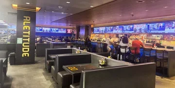 Seating area and TV screens at Aletitude restaurant, SFO