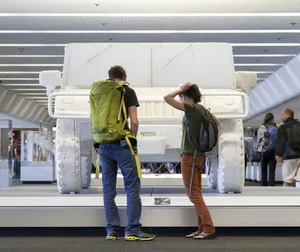 Airport passengers looking at art