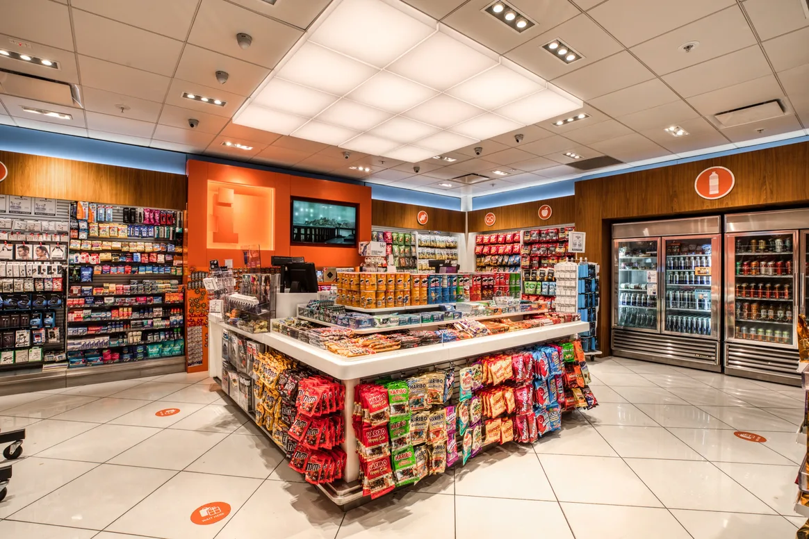 San Francisco Travel News interior with shelves of snacks, drinks, and travel accessories, centered around a counter with snacks.